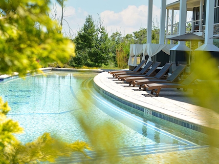 Luxurious poolside relaxation in an exclusive spa package at The Preserve Resort and Spa, Rhode Island, with elegant loungers.