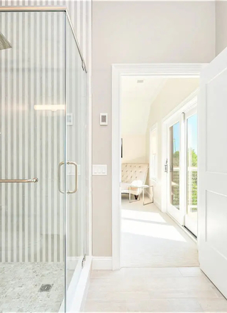 Stylish bathroom at Hilltop Lodge Residences with elegant fixtures, glass shower, and natural lighting.