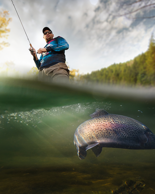 A serene moment of an angler casting a line amid the tranquil nature at The Preserve Resort & Spa's fishing ponds.