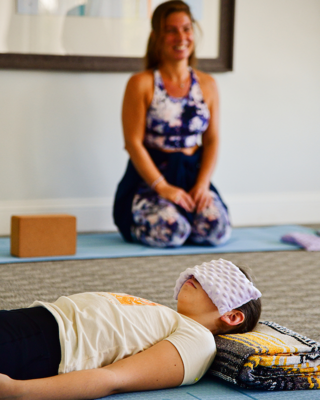 Yoga instructor smiling at kids' yoga class at Preserve Resort & Spa, promoting joy and well-being.