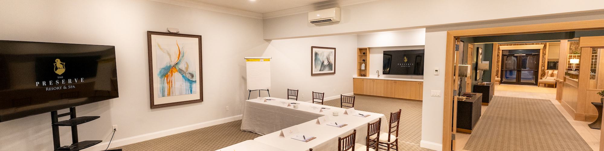 Elegant conference room setup at Preserve Resort & Spa event venue with a long table and chairs.