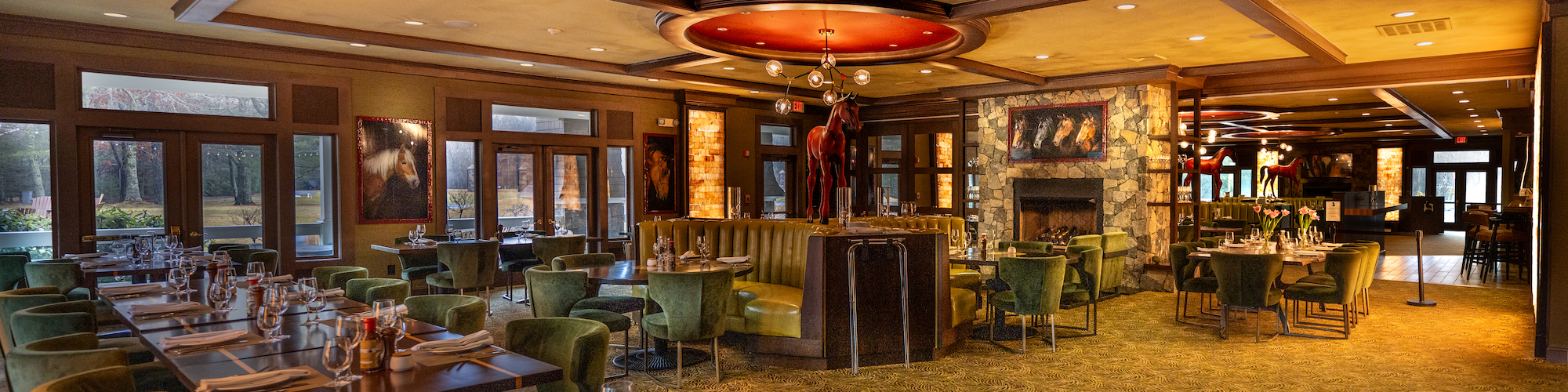 Elegant dining setup with green chairs and circular chandeliers at Preserve Resort & Spa, perfect for sizable events.