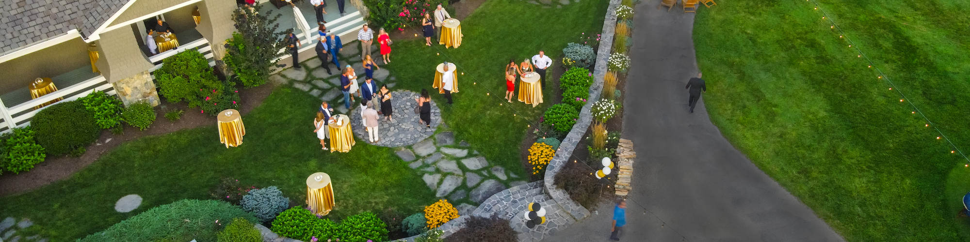 Guests enjoy an evening at The Preserve Resort & Spa's main lodge lawn, a perfect event venue under a twilight sky.