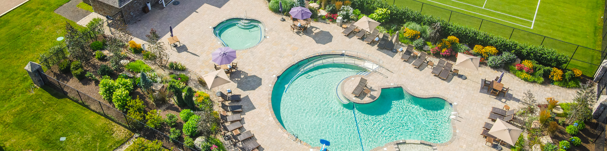 Aerial view of The Preserve Resort & Spa's Pool House and ram-shaped swimming pool, a premier event venue.