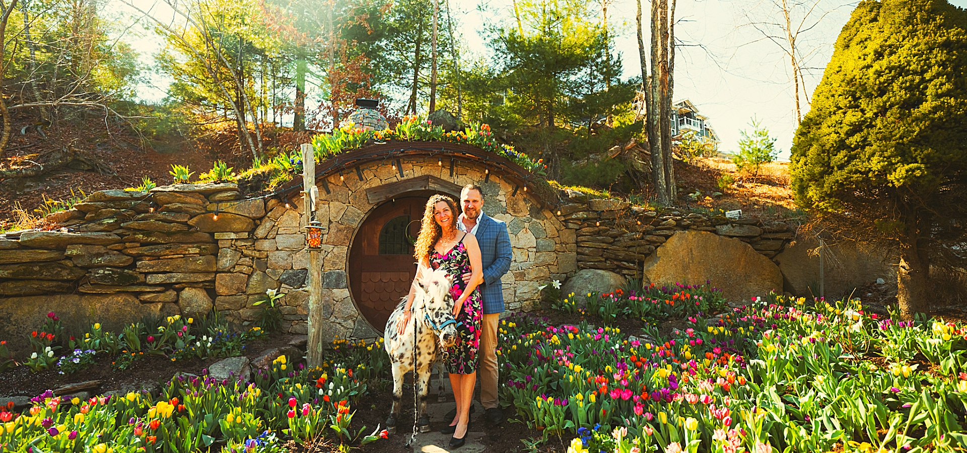 Couple and pony at Hobbit House amid vibrant spring blooms at The Preserve.