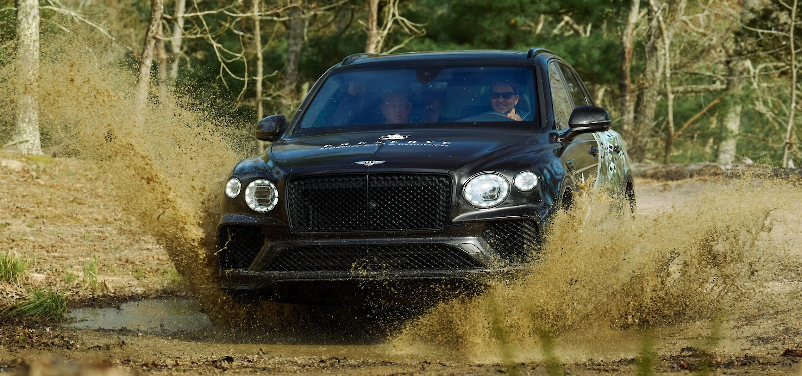 Bentley Bentayga splashing through a muddy trail at The Preserve Sporting Club.