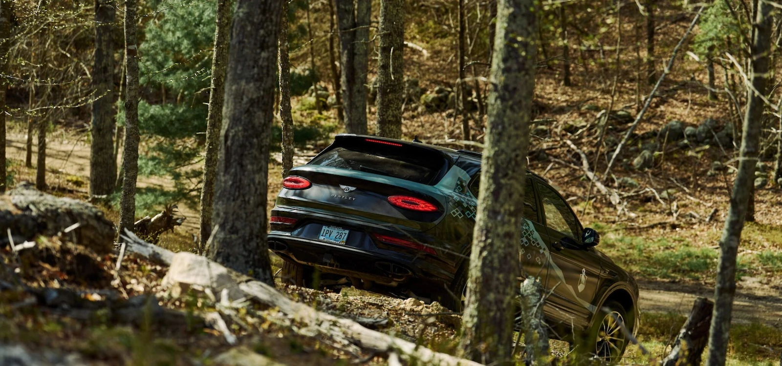 Bentley Bentayga driving through a wooded area at The Preserve Sporting Club.