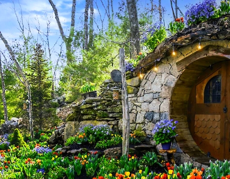 Hobbit House surrounded by vibrant flowers at The Preserve Sporting Club & Resort